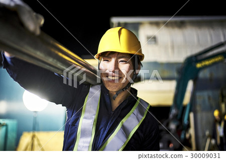 Construction site Male carrying night pipe Construction site Male carrying night pipe 30009031