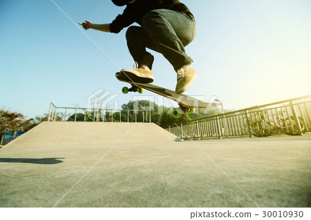 young skateboarder legs skateboarding at skatepark young skateboarder legs skateboarding at skatepark 30010930