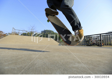 young skateboarder legs skateboarding at skatepark young skateboarder legs skateboarding at skatepark 30010934