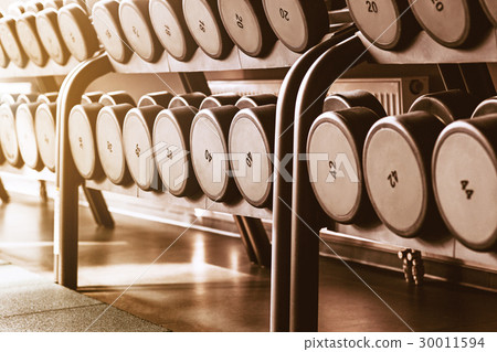 Rows of dumbbells in the gym Rows of dumbbells in the gym 30011594