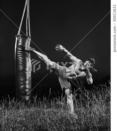 Monochrome shots of a male boxer training with a 30011631