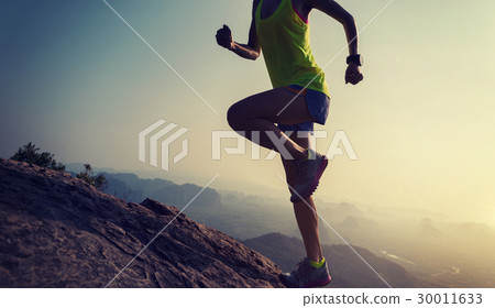 woman trail runner running at mountain top 30011633