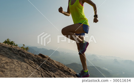 woman trail runner running at mountain top 30011634