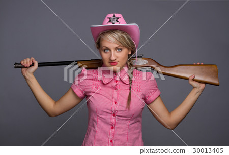 Attractive cawbow girl with shot gun over back Attractive cawbow girl with shot gun over back 30013405