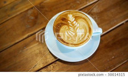 Hot coffee on a wooden table. Hot coffee on a wooden table. 30014315