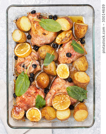 Baked chicken leg quarter with potatoes and lemon Baked chicken leg quarter with potatoes and lemon 30014689
