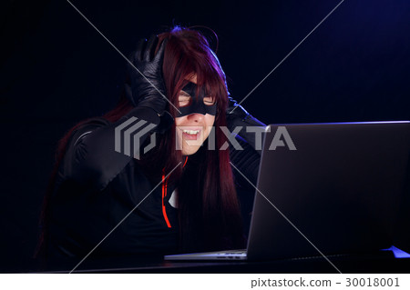 Dangerous thief next to laptop 30018001