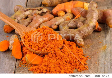 Turmeric and turmeric powder on wooden background 30018573