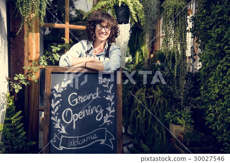 Adult Woman Standing with Grand Opening Sign Adult Woman Standing with Grand Opening Sign 30027546