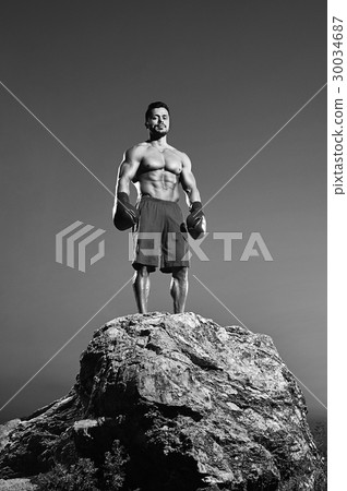 Monochrome shots of a fierce male boxer training 30034687