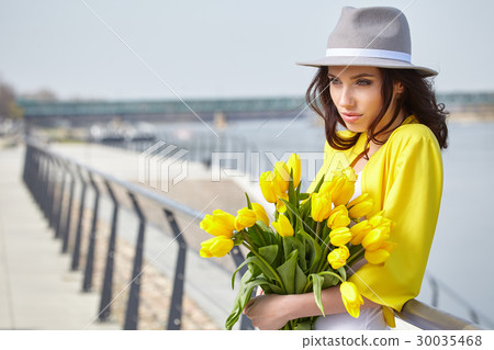 Romantic woman with flowers in their hands Romantic woman with flowers in their hands 30035468