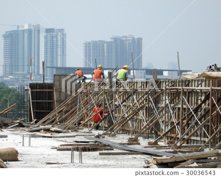 Construction workers fabricating timber form work 30036543