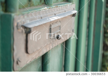 closeup of bronze mailbox on green metallic door closeup of bronze mailbox on green metallic door 30036653