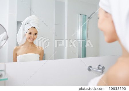 Beautiful Young Woman applying facial moisturizing cream.Skincare concept Beautiful Young Woman applying facial moisturizing cream.Skincare concept 30038590