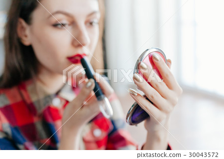 beautiful young woman make-up in the mirror 30043572