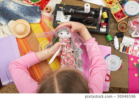 girl sews doll clothes top view sewing accessories 30046596