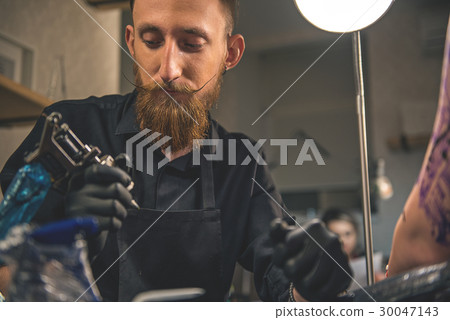 Pensive man looking at instrument in salon Pensive man looking at instrument in salon 30047143