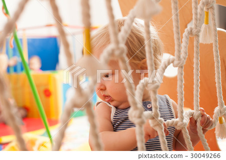 The baby playing on the playground The baby playing on the playground 30049266