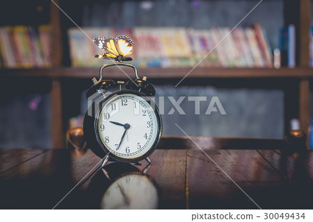 Antique clock on a wooden table 30049434