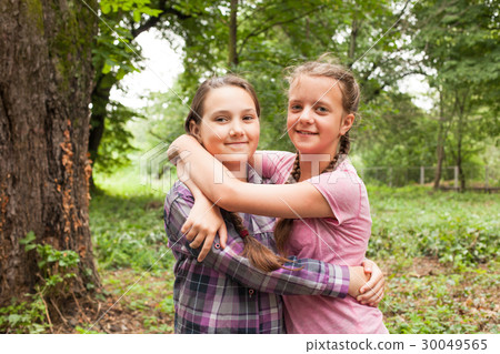 Two sisters hugs 30049565