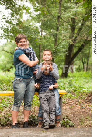 Mother with sons outdoors 30049567
