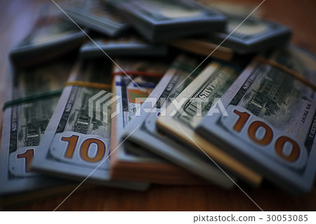 Large bundles of money on the table 30053085