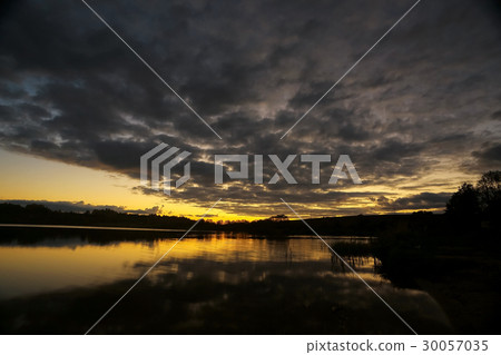 Beautiful sunset on the lake shore Beautiful sunset on the lake shore 30057035