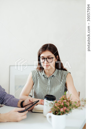 Two creative designers working at white office. 30057994