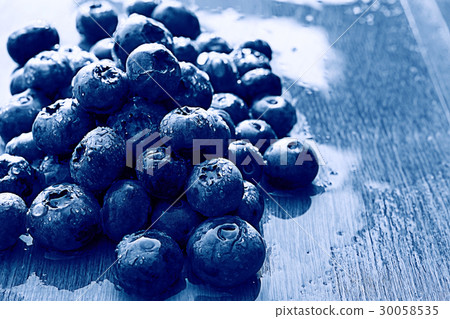 fresh berries blueberries close-up scattered black and white fresh berries blueberries close-up scattered black and white 30058535