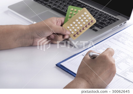 doctor hand holding birth control pills doctor hand holding birth control pills 30062645