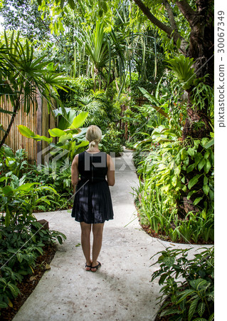 Girl standing alone on road cross in the jungle in 30067349