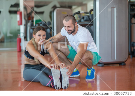 Young people involved in sports. Woman stretching Young people involved in sports. Woman stretching 30067733