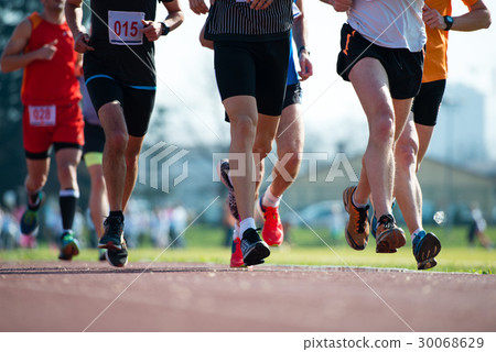 Group of marathon racers runningon the track Group of marathon racers runningon the track 30068629