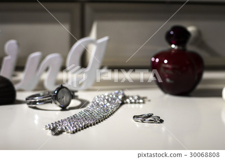 Crystal braslet, watch and silver rings lie  30068808