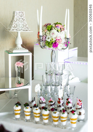 Cold desserts in glass shots stand on white table Cold desserts in glass shots stand on white table 30068846