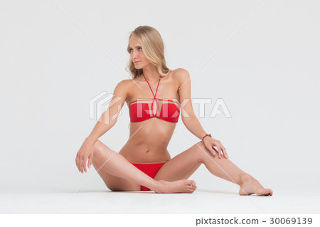 Girl with perfect body in red underwear on white Girl with perfect body in red underwear on white 30069139