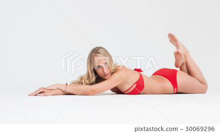 Girl with perfect body in red underwear on white 30069296