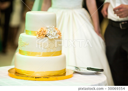Beautiful wedding cake decorated with yellow  30069354