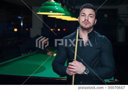 Two male adults playing snooker game in club 30070687