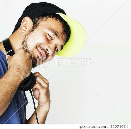 young asian man in hat and headphones listening young asian man in hat and headphones listening 30071684