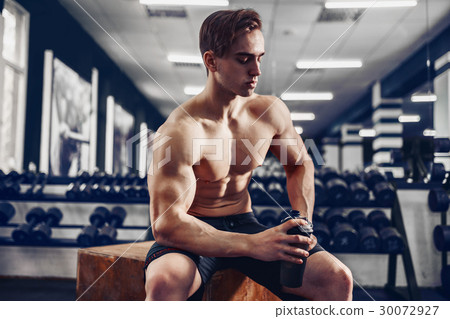 very power athletic guy, relaxing after workou in 30072927