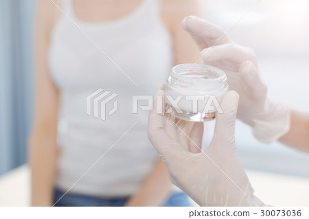 Skillful doctor using special medical cream in the Skillful doctor using special medical cream in the 30073036