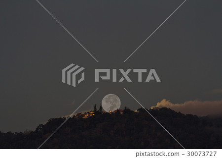 Supermoon setting over Buddhist temple on mountain Supermoon setting over Buddhist temple on mountain 30073727