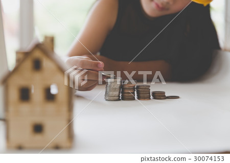 asian girl put coin to money stack - money saving asian girl put coin to money stack - money saving 30074153