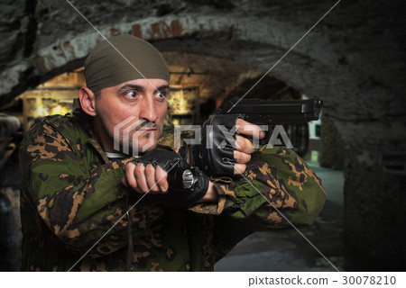 Portrait of the soldier with the gun in hands 30078210