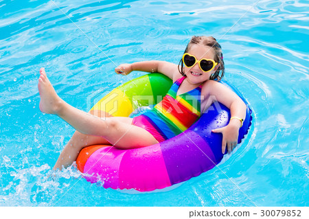 Child with toy ring in swimming pool 30079852