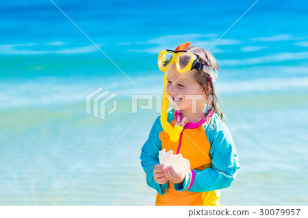 Child snorkeling on tropical beach 30079957
