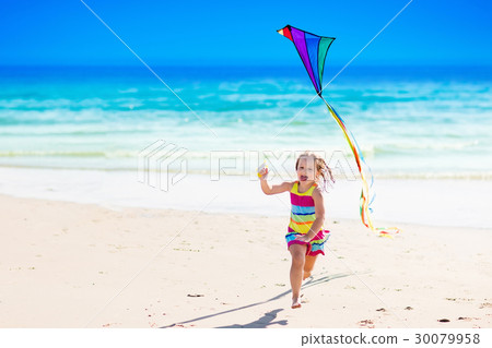 Child flying kite on tropical beach 30079958