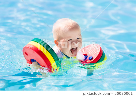 Little baby boy playing in swimming pool Little baby boy playing in swimming pool 30080061
