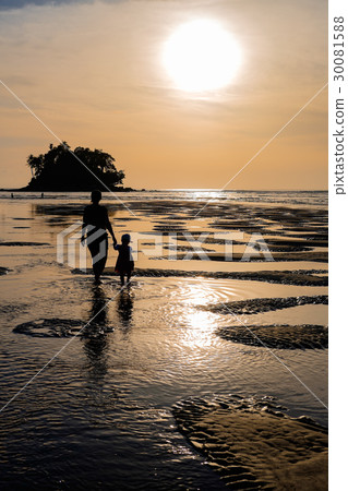 Mother walks with daughter at sea sunset Mother walks with daughter at sea sunset 30081588